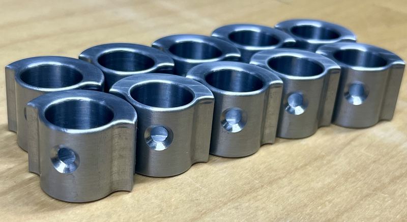 A set of machined split clamp blocks with large bores and cross-drilled holes