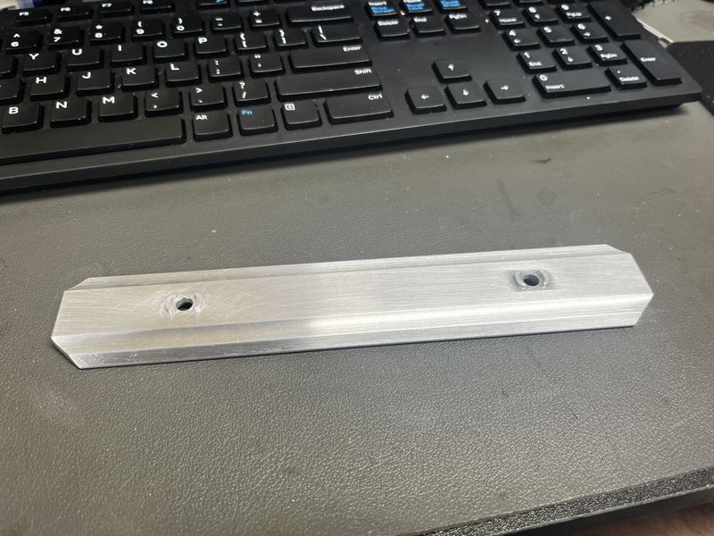 Long chamfered aluminum rail with two countersunk holes