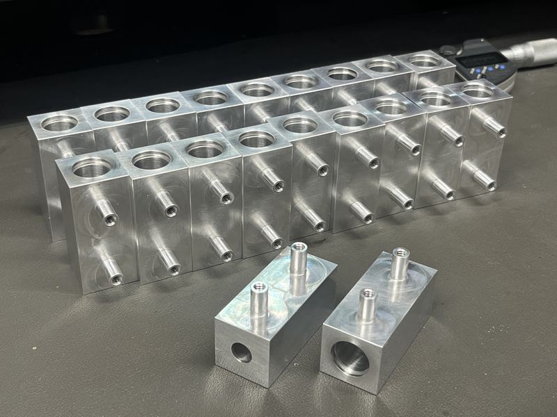 Rows of machined aluminum manifold blocks